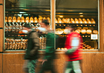 Blurred motion of people walking in bakery 