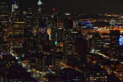 Aerial view of city lit up at night