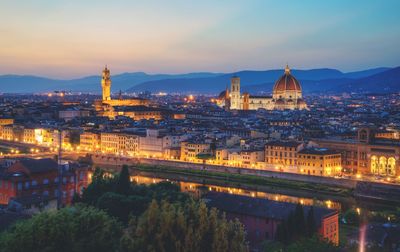 High angle view of duomo santa maria del fiore amidst buildings in illuminated town at night