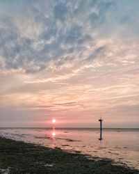 View of lighthouse at beach during sunset