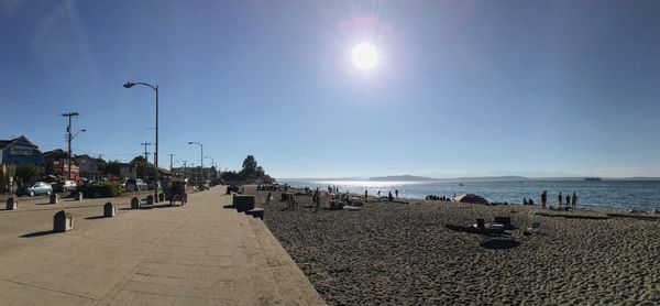 People on beach against blue sky