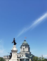 Low angle view of a building against blue sky