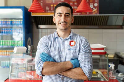 Portrait of a smiling young man standing in store