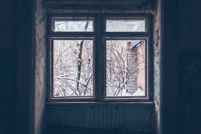 Damaged window of abandoned building in chernobyl zone at pripyat 
