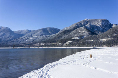 Scenic view of snowcapped mountains against clear blue sky