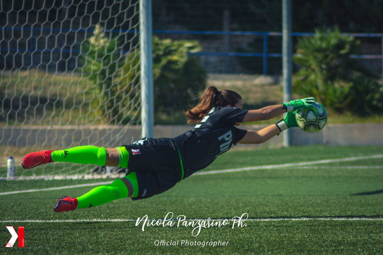 WOMAN PLAYING SOCCER BALL