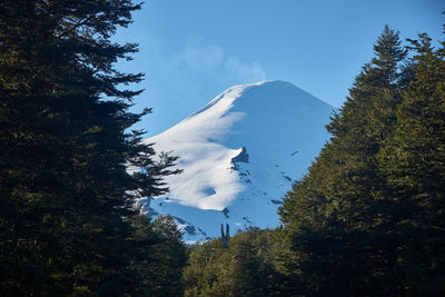 Low angle view of snowcapped mountain against sky