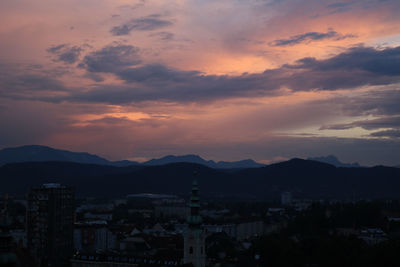 Silhouette buildings against sky at sunset