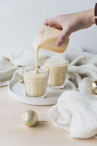 Close-up of hand pouring coffee cup