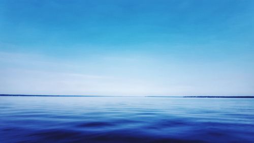 Scenic view of sea against blue sky