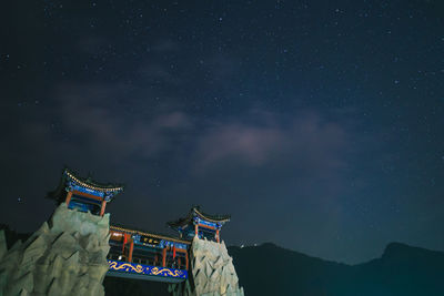 Low angle view of traditional building against sky at night