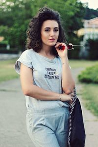 Portrait of beautiful young woman standing outdoors