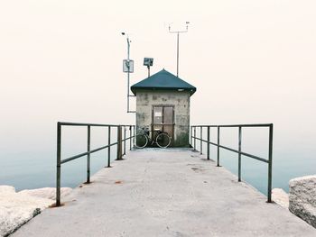 Built structure by sea against clear sky