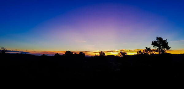 Scenic view of silhouette landscape against sky at sunset