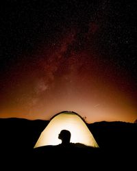 Silhouette of man against star field at night