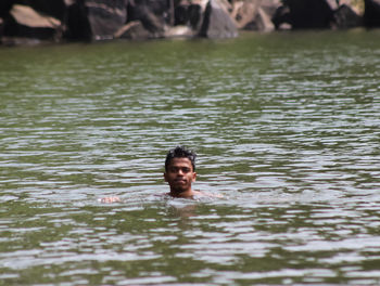 Portrait of man swimming in lake