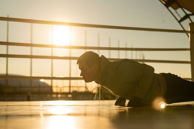 Low angle view of young man sitting on floor