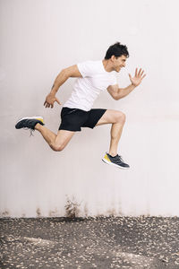 Isolated male athlete jumping outdoors