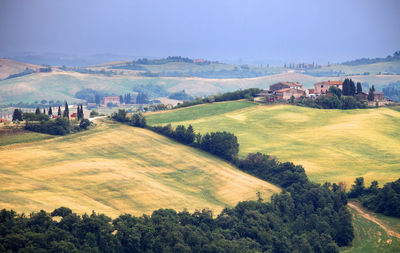 Scenic view of landscape and buildings against sky