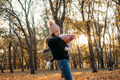 Family fall social distancing activities. happy family mom and toddler baby girl playing outdoors