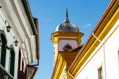 Low angle view of yellow buildings against sky