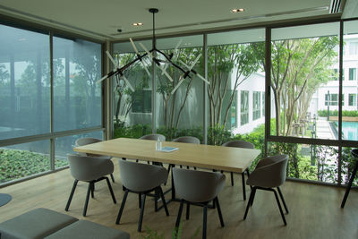 Empty chairs and table against window at home