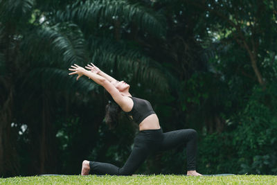 Full length of woman exercising at park