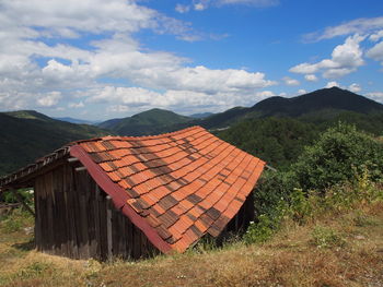 House on mountain against sky