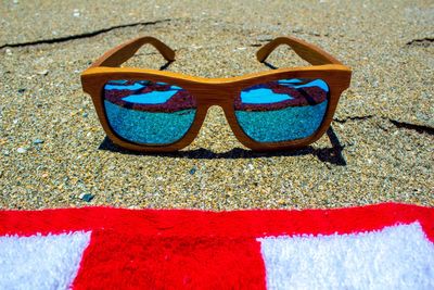 Close-up of sunglasses on beach