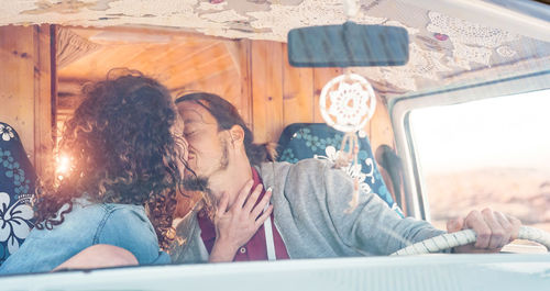 Couple kissing in caravan
