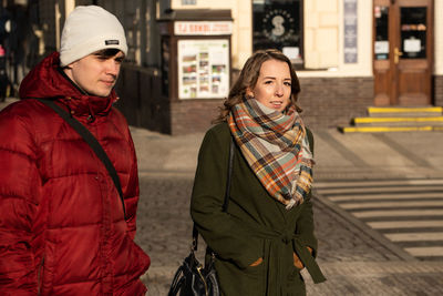 Happy woman standing in city during winter