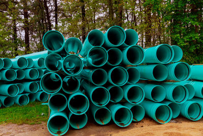 Stack of pipes on field