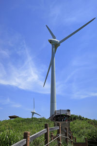 Low angle view of windmill against sky