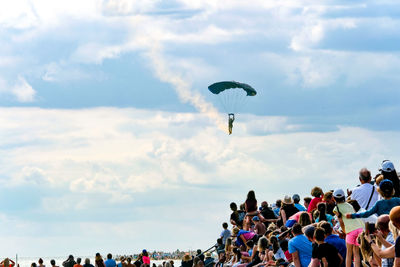 People paragliding against sky