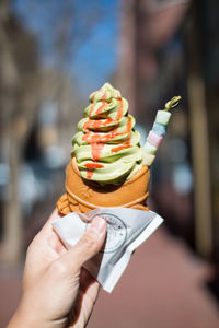 Cropped image of woman holding ice cream