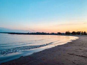 Scenic view of beach against sky during sunset