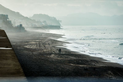 Scenic view of sea against sky in foggy morning