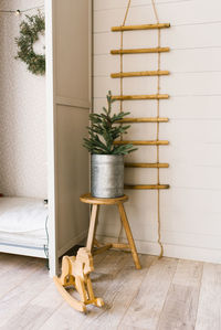 Christmas tree in an iron pot near the closet in the children's room