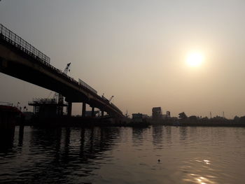 Scenic view of bridge over city against sky during sunset