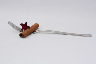 High angle view of ring on wood against white background