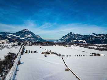 Snow covered mountain against blue sky