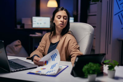 Young woman using laptop at office