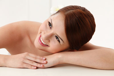 Smiling shirtless young woman at home