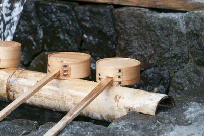 Close-up of bamboo ladles on rock