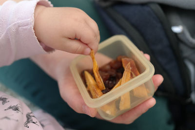 Close-up of hand holding bowl