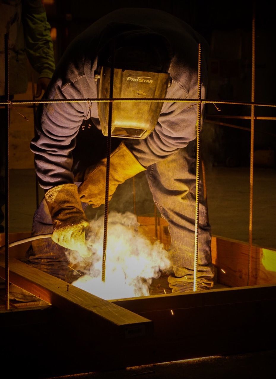 LOW SECTION OF MAN WEARING SHOES AT NIGHT