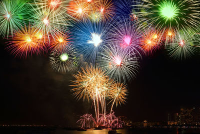 Low angle view of firework display at night