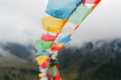 Close-up of colorful prayer flags hanging outdoors