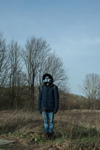 Full length of man standing on field against sky