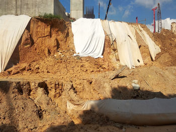 Clothes drying on clothesline on land against building